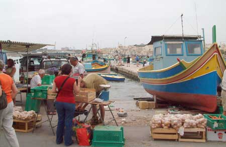 Shopping at the market in front of the harbour in Marsaxlook